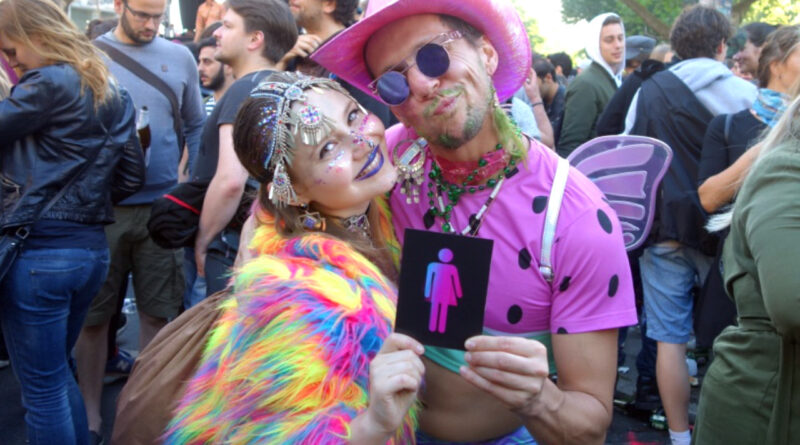 Two colorful people with CO-WC sign at the Carnival of Cultures in Berlin 2017.