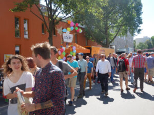 Shot from a distance of the CO-WC information booth at the Lesbian and Gay City Festival in Berlin.