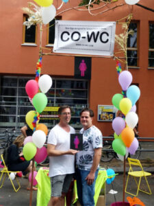 Two people at the Lesbian and Gay City Festival at the CO-WC information booth.