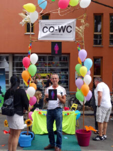 Person with CO-WC sign at the Lesbian Gay and City Festival in Berlin.