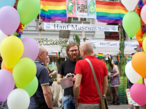 CO-WC founder Paul Jonczyk chats with two elderly people at the Lesbian and Gay City Festival.