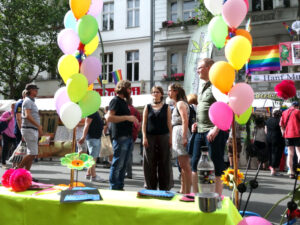 CO-WC founder Paul Jonczyk talks with two visitors at the Lesbian and Gay City Festival Berlin.